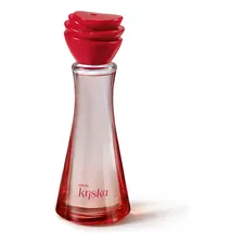 Frasco de perfume Natura Kriska em miniatura de 25ml com tampa vermelha em formato de pétalas e vidro transparente levemente rosado